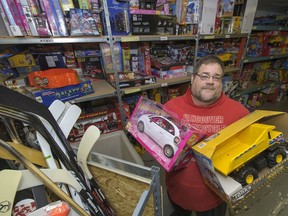 The Lower Mainland Christmas Bureau is offering free coffee and mini donuts in exchange for donations of new, unwrapped toys. Chris Bayliss at the Vancouver warehouse of the Lower Mainland Christmas Bureau is pictured in this 2013 file photo.