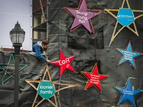 Stars and lights are replaced after a fire damaged a few of them in front of St. Paul's Hospital in Vancouver on Nov. 22, 2020.
