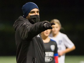 Alfredo Valente coaches his Metro-Ford youth soccer team on Tuesday night at Mobilio Field in Coquitlam. Valente is also the Coquitlam Metro-Ford technical director.