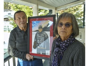 Pete and Muriel Sasakamoose stand outside their home near Pinantan Lake, remembering Pete's brother Fred Sasakamoose who died Tuesday due to COVID-19 complications. Fred's nephew Jordan Sasakamoose recently painted this portrait of his famous NHLer uncle standing with hockey stick and gloves on Sandy Lake, just steps away from his home northwest of Prince Albert, Sask.