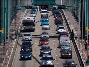 CP-Web. Traffic crosses over the Lions Gate Bridge from North Vancouver into Vancouver on July 2, 2015. Motorists would have to pay a fee to drive into downtown Vancouver under the city's plan to slow climate change but one expert warns it could pose financial hardship for some.