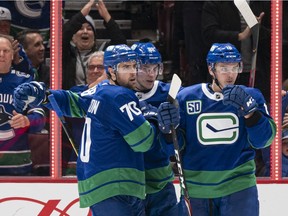 Tanner Pearson, left, Adam Gaudette and Jake Virtanen celebrate after scoring against the San Jose Sharks on Jan. 18, 2020 at Rogers Arena in Vancouver.