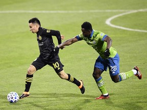 Lucas Zelarayan of Columbus Crew controls the ball against Yeimar Gomez of Seattle Sounders in the first half during the MLS Cup Final at MAPFRE Stadium in Columbus, Ohio, on Saturday, Dec. 12, 2020.