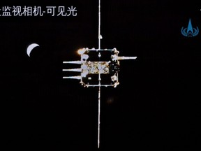 This picture taken and released on Dec. 6, 2020 by the China National Space Administration (CNSA) via CNS shows the orbiter of China's Chang'e-5 lunar probe approaching the ascender.