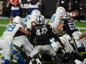 L.A. Chargers quarterback Justin Herbert (10) lunges for the goal line before sneaking the ball over for the game-winning touchdown against the Las Vegas Raiders in overtime at Allegiant Stadium in Las Vegas.