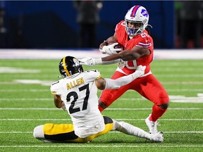 Dec 13, 2020; Orchard Park, New York, USA; Buffalo Bills running back Zack Moss (20) avoids the tackle attempt of Pittsburgh Steelers safety Marcus Allen (27) during the fourth quarter at Bills Stadium. Mandatory Credit: Rich Barnes-USA TODAY Sports