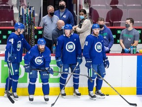 Canucks Elias Pettersson, Jordie Benn, Brock Boeser and Tanner Pearson (left to right) are the only ones not masked up here at last July's short training camp at Rogers Arena.
