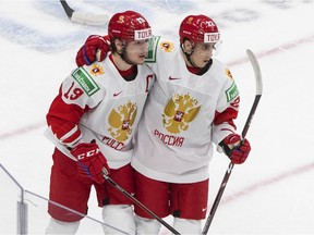 Russia's Vasili Podkolzin (19) and Marat Khusnutdinov (22) celebrate a goal against Austria during first period IIHF World Junior Hockey Championship action in Edmonton on Tuesday, December 29, 2020.
