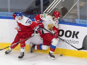 Russia forward Vasili Podkolzin (19) is checked by Czech Republic forward Adam Raska (26) during third period IIHF World Junior Hockey Championship action in Edmonton on Sunday, December 27, 2020.