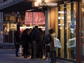 VANCOUVER,BC:DECEMBER 26, 2018 -- A small line of shoppers form outside LuLulemon on Robson Street while waiting for the store to open for Boxing Day sales in Vancouver, BC, December, 26, 2018.