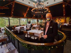 Event coordinator Makda Gino, left, and general manager Richard Baker inside Seasons in the Park restaurant at Queen Elizabeth Park in Vancouver on Dec. 30. City restaurants are expecting a quiet New Year's Eve, considering public health orders that put a lid on festive celebrations.