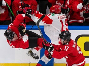 Kaiden Guhle #21 of Canada is dropped by Vasili Podkolzin #19 of Russia during the 2021 IIHF World Junior Championship semifinals at Rogers Place on January 4, 2021 in Edmonton, Canada.