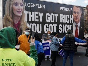 A truck with a message criticizing Republican Senators Kelly Loeffler and David Perdue is seen at a campaign event for Democratic U.S. Senate candidate Raphael Warnock in Atlanta, Georgia, U.S. January 5, 2021.
