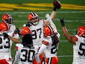 Browns' Porter Gustin (97) celebrates an interception during the AFC Wild Card Playoff game against the Steelers at Heinz Field in Pittsburgh, Sunday, Jan. 10, 2021.