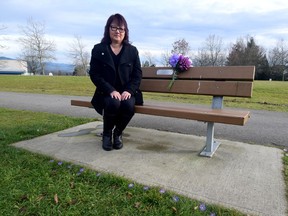 Carol Todd sits on a memorial bench for her daughter Amanda, who committed suicide after being cyberbullied. A stranger decorated the bench with Amanda's favourite purple flowers on her birthday recently.