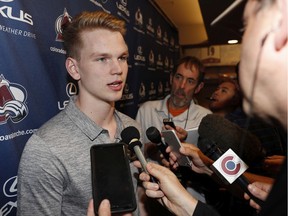Bowen Byram, the Colorado Avalanche's first-round selection in the NHL hockey draft and fourth pick overall, talks with reporters during a news conference to introduce the Avalanche's selections to the local media in the team's locker room Tuesday, June 25, 2019, in Denver.
