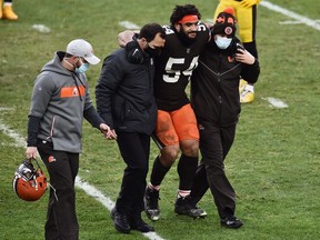 Cleveland Browns defensive end Olivier Vernon is helped off the field during the second half of their National Football League game against the Pittsburgh Steelers at FirstEnergy Stadium in Cleveland, Ohio, on Jan. 3, 2021.