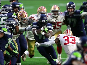 Seattle Seahawks running back Alex Collins (41) runs the ball against the San Francisco 49ers during the second half at State Farm Stadium