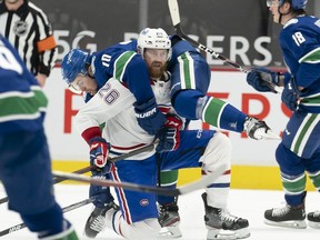 Vancouver Canucks left wing Tanner Pearson (70) gets tangled up with Montreal Canadiens defenseman Jeff Petry (26) during first period NHL action in Vancouver, Wednesday, Jan. 20, 2021.