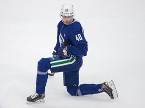 Vancouver Canucks' Elias Pettersson, of Sweden, stretches during the NHL hockey team's training camp in Vancouver, on Friday, January 8, 2021.