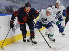 New Vancouver Canucks' defenceman Nate Schmidt battles with Jesse Puljujarvi of the Edmonton Oilers during Thursday's NHL game in the Alberta capital.