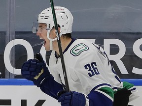 Nils Hoglander celebrates a second-period goal against the Edmonton Oilers at Rogers Place on Wednesday. The Canucks won their first game of the season 5-3.