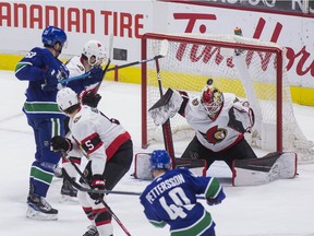 Elias Pettersson (40) scores on Ottawa Senators goalie Marcus Hogberg (1) in the second period at Rogers Arena.