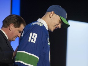 Vasili Podkolzin walks to the podium with Canucks GM Jim Benning after being picked tenth overall in the 2019 NHL Draft at Rogers Arena in Vancouver.