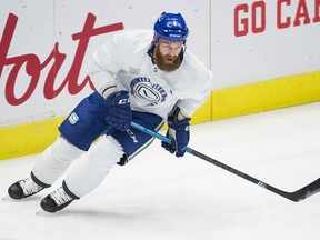 Jordie Benn of the Vancouver Canucks, above, will be watching his team on TV for the next week after being forced to the sideline by NHL COVID-19 protocols. His teammate and roommate J.T. Miller will also miss the Canucks' first week of the season.