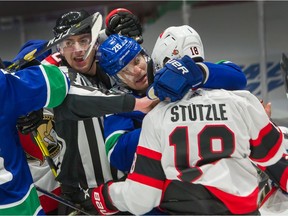 ‘It’s always been not a struggle, but a challenge to walk that line in my career,’ Antoine Roussel, here mixing it up with Ottawa Senators rookie Tim Stutzle, says of his rugged, competitive ways.