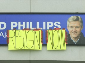 Homemade signs were taped to signage outside the plaza on Rossland Road West in Ajax where former Ontario finance minister Rod Phillips has his constituency office.