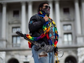 A protester carries a crossbow outside the capitol in Harrisburg, Pennsylvania on Jan. 17, 2021, during a nationwide protest called by anti-government and far-right groups supporting U.S. President Donald Trump and his claim of electoral fraud in the Nov. 3 presidential election.