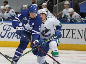 Maple Leafs centre Auston Matthews battles for the puck with Canucks winger Brock Boeser as Vancouver was dominated at Scotiabank Arena in Toronto on Thursday night.