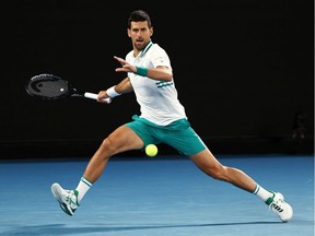 Novak Djokovic plays a forehand in his Men's Singles fourth round match against Milos Raonic during day seven of the 2021 Australian Open at Melbourne Park on February 14, 2021, in Melbourne, Australia.