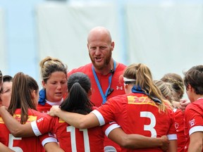 Canada's team coach John Tait (C) talks to players during the HSBC World Rugby Women's Sevens Series match between Canada and Fiji on May 29, 2016 at the Gabriel Montpied stadium in Clermont-Ferrand, central France.