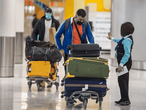 Travellers arriving at Pearson International Airport are guided to their COVID-19 quarantine hotel, Wednesday February 24, 2021.