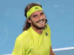Greece's Stefanos Tsitsipas smiles as he celebrates his victory over Spain's Rafael Nadal during their men's quarterfinal match at the Australian Open in Melbourne, Wednesday, Feb. 17, 2021.