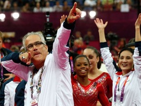 In this file photo taken on July 31, 2012, US women gymnastics team's coach John Geddert celebrates with the rest of the team after the US won gold in the women's team artistic gymnastics event at the London Olympic Games.