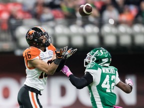 B.C. Lions' Bryan Burnham makes a reception as Saskatchewan Roughriders' Derrick Moncrief defends during the first half of a CFL football game in Vancouver on Oct. 18, 2019.