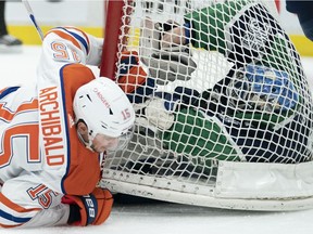 Edmonton Oilers right wing Josh Archibald (15) crashes into Vancouver Canucks goaltender Thatcher Demko (35) during first period NHL action in Vancouver, Thursday, February 25, 2021.