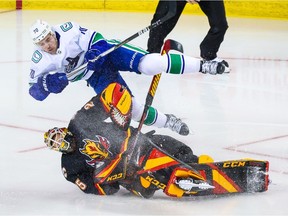 Calgary Flames goaltender Jacob Markstrom (25) and Vancouver Canucks left wing Tanner Pearson (70) collide during the second period at Scotiabank Saddledome.