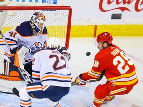 Edmonton Oilers goalie Mike Smith with a save on Dillon Dube of the Calgary Flames during NHL hockey in Calgary on Friday February 19, 2021. Al Charest / Postmedia