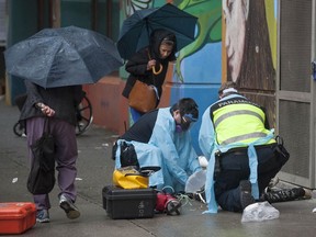 Paramedics help a drug overdose victim in Vancouver’s Downtown Eastside last year.