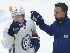 Jack Rathbone (left) on the ice with coach Travis Green during Vancouver Canucks training camp at Roger Arena in Vancouver on Jan. 12, 2021. 



(NICK PROCAYLO/PNG) 



00063479A ORG XMIT: 00063479A [PNG Merlin Archive]