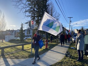 Some teachers and staff at École Woodward Hill Elementary School in south Newton, Surrey, B.C. hold a walk-in on Feb. 23 to express solidarity with other schools dealing with COVID variants.
