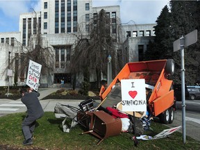 Strathcona resident Adam Levy dumps garbage from Strathcona Park at Vancouver City Hall on Feb. 24 to protest the continuing camp of tents at the park.