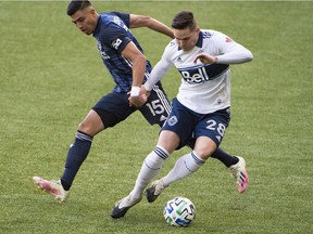 Los Angeles Galaxy midfielder Joe Corona defends Vancouver Whitecaps defender Jake Nerwinski (right) during the first half at Providence Park.