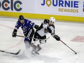 Vancouver Giants defenceman Marko Stacha tries to wheel away from Victoria Royals forward Brandon Cutler in Vancouver's 5-4 win Tuesday in Kamloops.