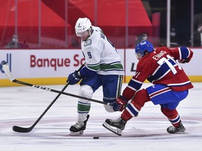 Moved to centre, Canuck J.T. Miller (here fending off Montreal Canadien Jake Evans during a Bell Centre game earlier this season) has two goals and four assists in the seven games that regular first-line pivot Elias Pettersson has been out of the lineup.