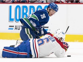 Antoine Roussel battles Shea Weber for puck possession during March 8 matchup at Rogers Arena.